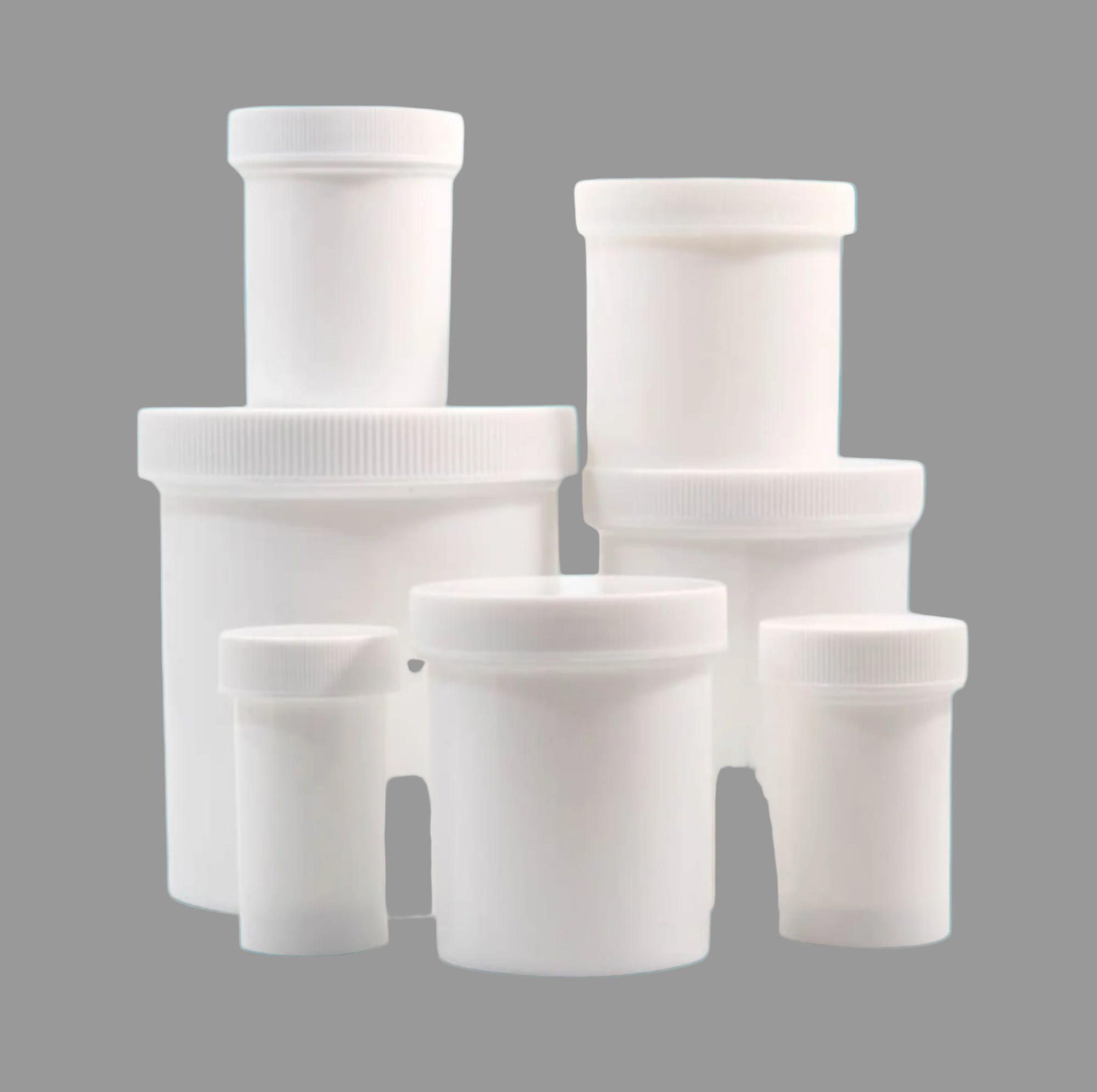 Set of white plastic containers with varying sizes on a gray background
Plastic ointment jars for pharmacy compounding and medication storage