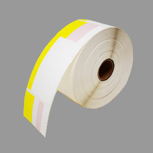 Roll of white labels with yellow border on a gray background